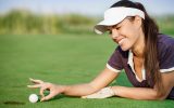 Woman pushing golf ball